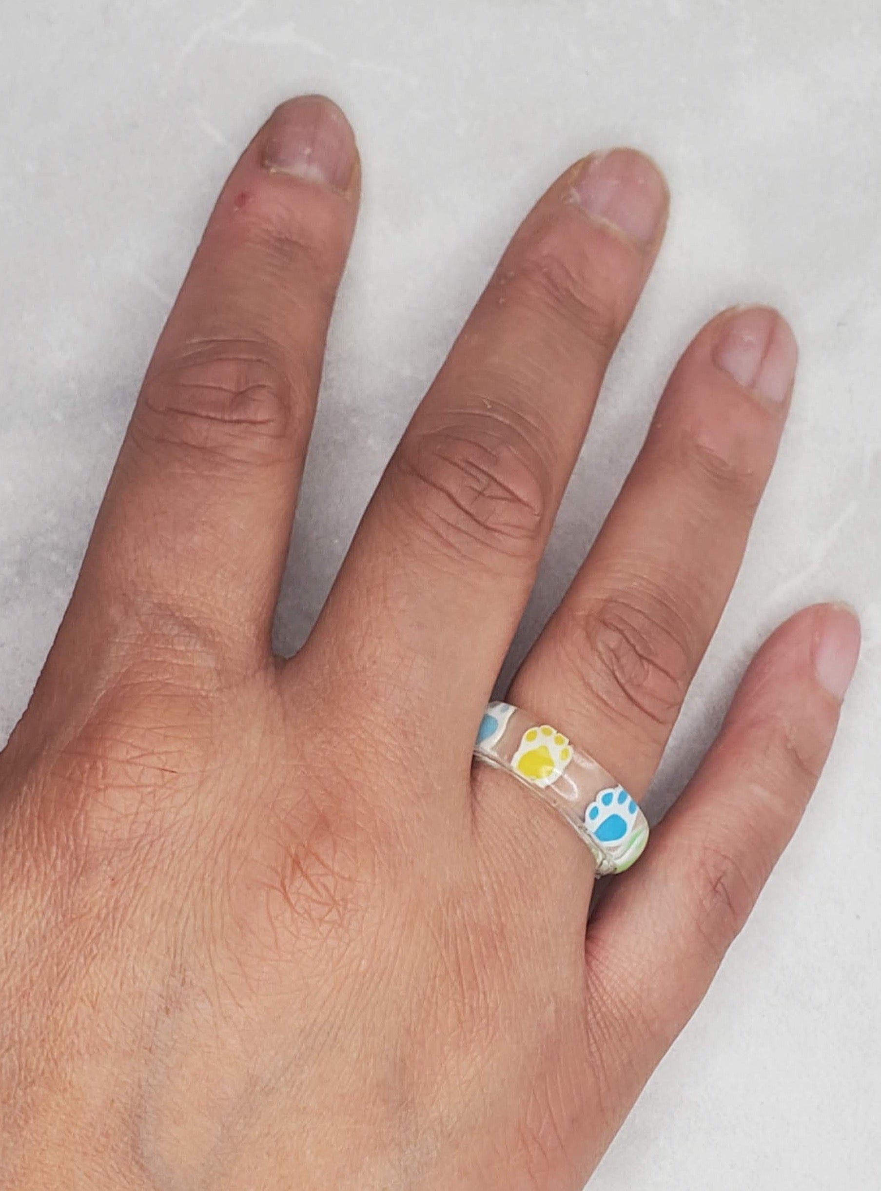 Paw print resin ring on hand - Braceliss