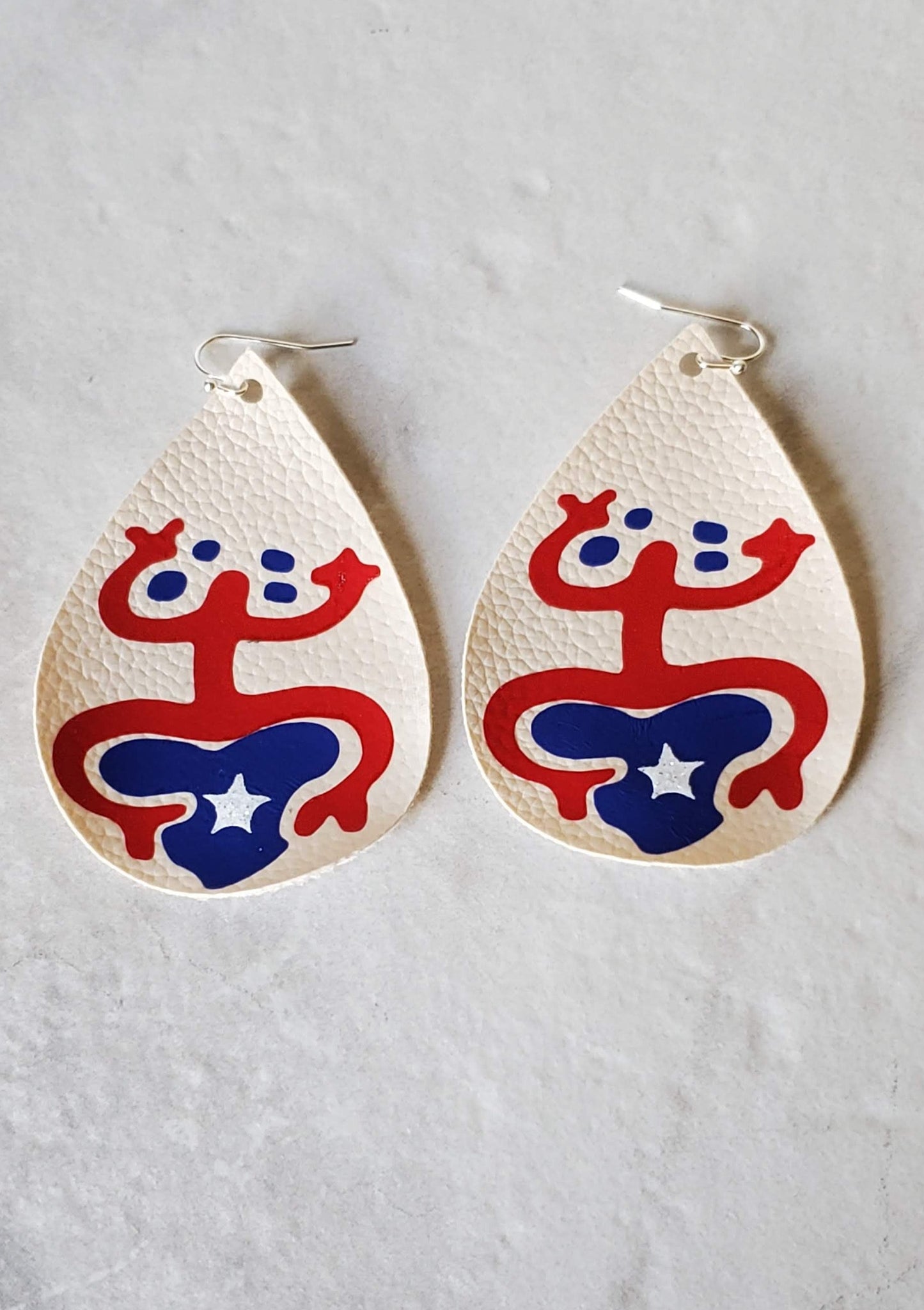 Taino coqui earrings - cream faux leather earrings laying flat - braceliss