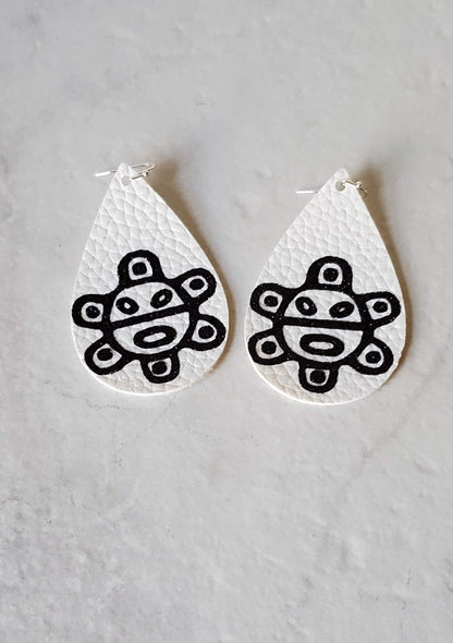 Taino sol earrings - white faux leather earrings laying flat - braceliss